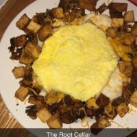 The Root Cellar Skillet · 2 biscuits covered with sausage and gravy, surrounded by home fries topped with eggs and che...