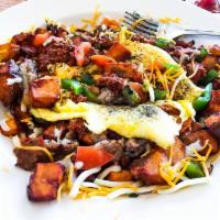 The Tornado Skillet · Home fries, sausage, green peppers, onions, tomatoes, topped with chili and cheddar Jack che...