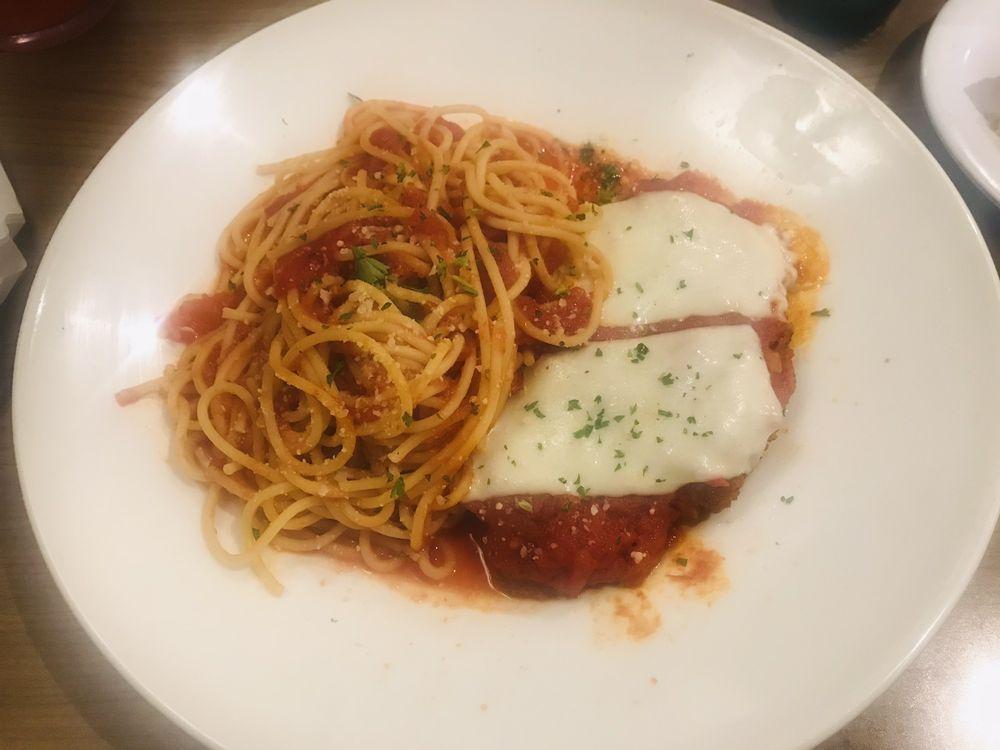 Chicken Parmigiana · Breaded, crisp chicken breast topped with marinara sauce and a generous portion of melted mozzarella cheese. Accompanied with spaghetti.