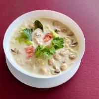 Tom Kha Soup · The most famous hot and sour soup with mushrooms, onions,tomatoes, galangal, kaffir lime lea...