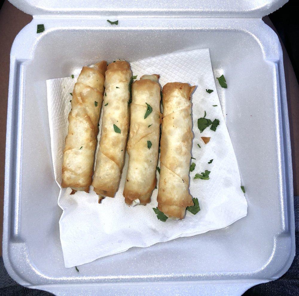Sigara Borek · Feta cheese with parsley wrapped in filo dough fried to a golden brown.