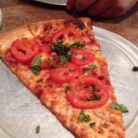 Margherita Pizza · Extra thin crust, Roma tomatoes, garlic, fresh basil and mozzarella.