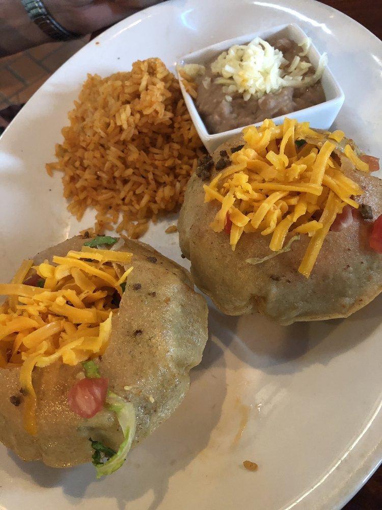 Tacos · Choice of 2 crispy, puffed or soft flour tacos filled with seasoned beef or shredded chicken served with rice and refried beans.
