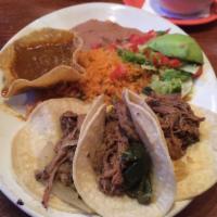 Brisket Tacos · 3 slow roasted corn tortilla brisket tacos served with Spanish rice, beans and spicy gravy o...