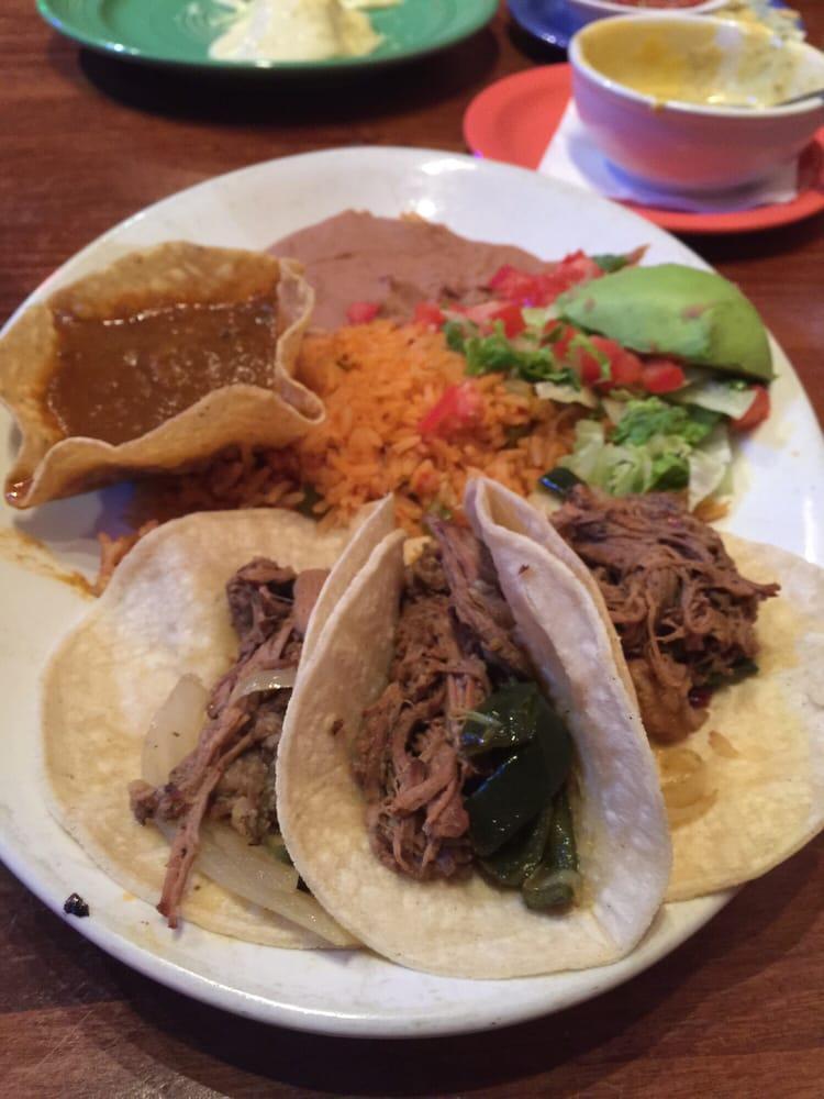 Brisket Tacos · 3 slow roasted corn tortilla brisket tacos served with Spanish rice, beans and spicy gravy on the side.
