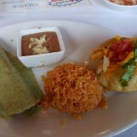 Maria · Avocado enchilada with cilantro cream sauce and a chicken
puffy taco. Served with Spanish ri...