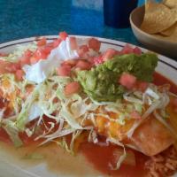 Burrito Tapatio · Soft flour tortilla filled with rice, beans, cheese, choice of beef,or chicken, and covered ...