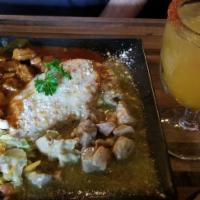 Chile Verde · Chunks of pork in a tomatillo sauce seasoned with spices. Gluten free.