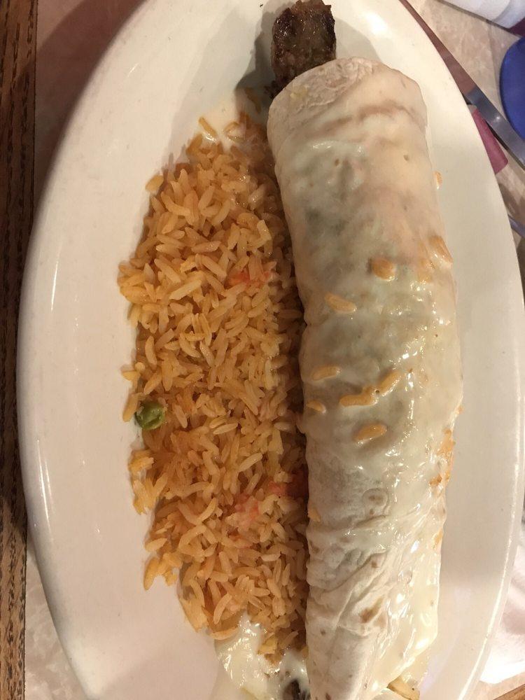 Burrito Grande · A gigantic burrito stuffed with queso, steak or chicken, black beans, rice, sour cream and tomatoes, covered with salsa.