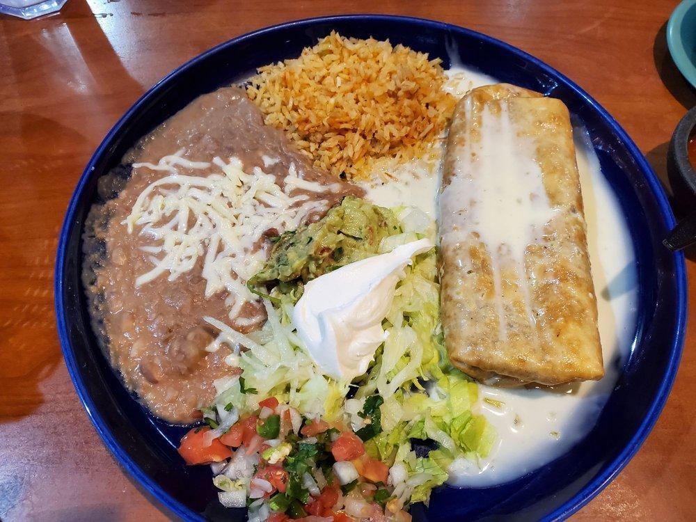 Chimichanga · Deep fried flour tortilla stuffed with chicken, ground or shredded beef covered with cheese sauce. Served with rice, refried beans, lettuce, pico de gallo, guacamole and sour cream.