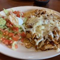Seasoned Chicken Salad · Strips of seasoned chicken on top of rice and covered with cheese. Served with lettuce, toma...