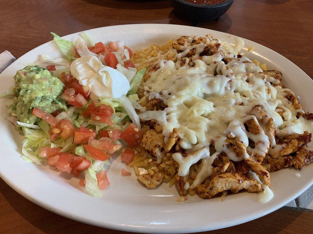 Seasoned Chicken Salad · Strips of seasoned chicken on top of rice and covered with cheese. Served with lettuce, tomatoes, sour cream and guacamole.
