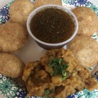 Pani Puri · 6 round puffes up puri with yellow peas, potatoes and spices, and special spiced mint pani.