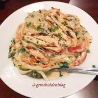 Primavera · Fettuccine pasta in a creamy Parmesan sauce with spinach, roasted peppers, zucchini and carr...