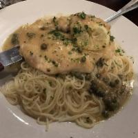 Chicken Piccata · Thin tender cutlet in lemon butter wine sauce with capers over angel hair pasta.