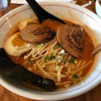 Tonkotsu Ramen · Rich pork and chicken broth topped with enoki cmushrooms, sauteed cabbage, chopped spring on...