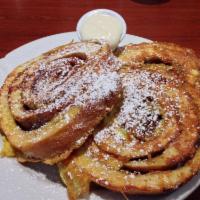 French Toast · Sprinkled with powdered sugar and served with a side of warm maple syrup.