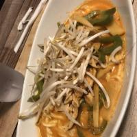 Red Curry · Simmered in a traditional coconut curry with bamboo shoot, green peppers, and fresh basil le...