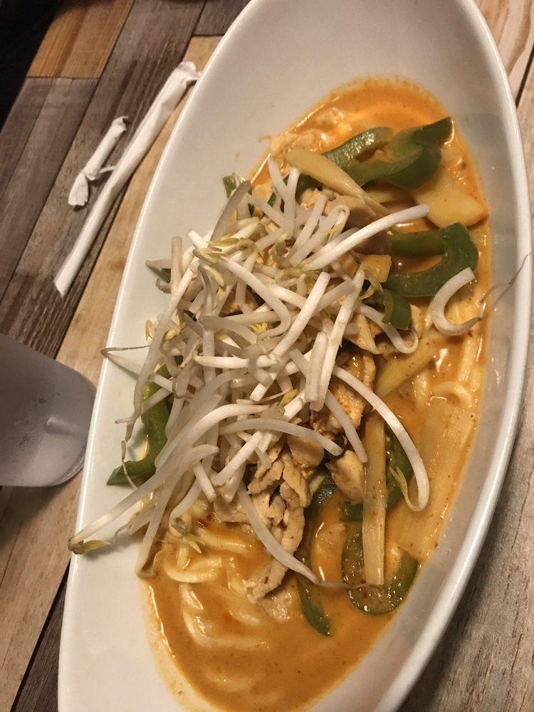 Red Curry · Simmered in a traditional coconut curry with bamboo shoot, green peppers, and fresh basil leaves.