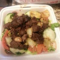 Shaken Beef · Beef cubes served on a bed of lettuce, onions and tomatoes.