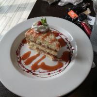 El Buren Coconut Cake · 3 layers of homemade coconut cake, guava filling and cream cheese frosting, topped with toas...