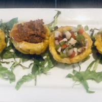 Tostones Rellenos · Fried green plantains (4 total) stuffed with 1 ropa vieja (shredded beef), 1 camaron (shrimp...
