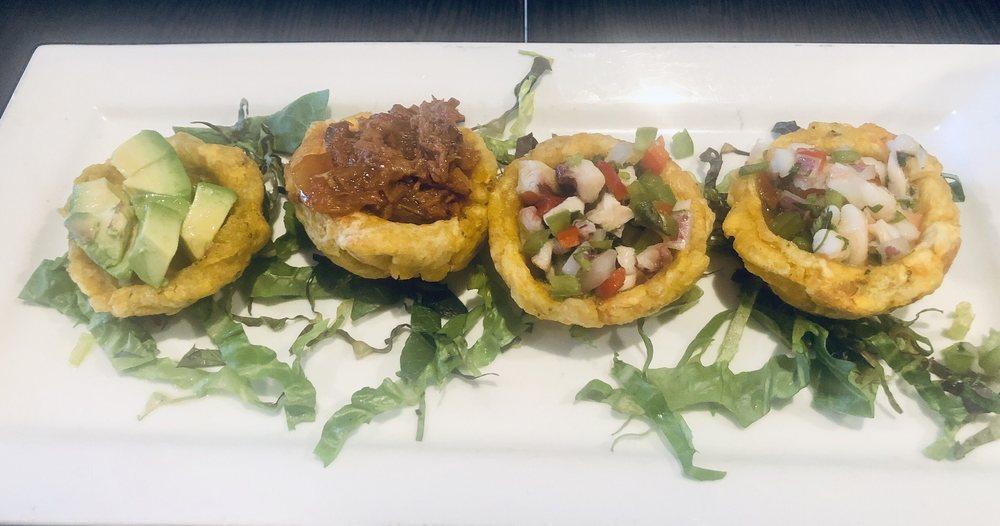 Tostones Rellenos · Fried green plantains (4 total) stuffed with 1 ropa vieja (shredded beef), 1 camaron (shrimp), 1 pulpo (octopus), 1 avocado.