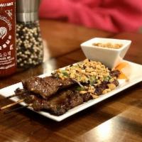 3 Beef Satay · Marinated beef skewered, topped with peanuts and scallion oil, served with peanut sauce.