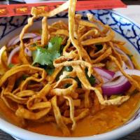 Curry Noodles · A specialty of the North, egg noodles are cooked in a red curry soup along with shallots. Me...