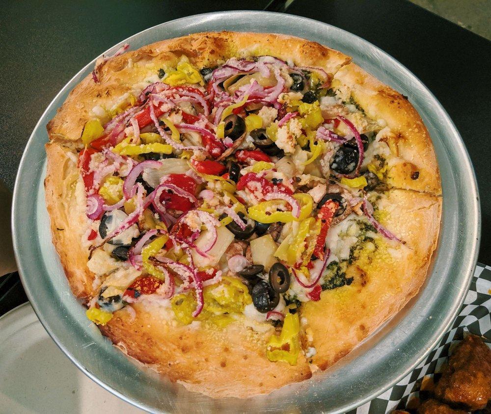 Antipasto Pizza · Pesto base, artichokes, garlic, roasted red peppers, black olives, red onions and pepperoncini.