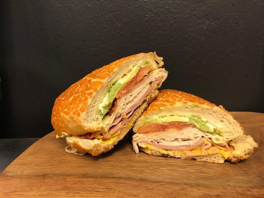 Ultimate Club Sandwich · Ham, turkey, bacon, tomato, avocado, mayo, mustard, and Swiss cheese on Dutch crunch.  