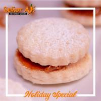 Alfajores · Delicate shortbread cookies filled with dulce de leche covered in powdered sugar.