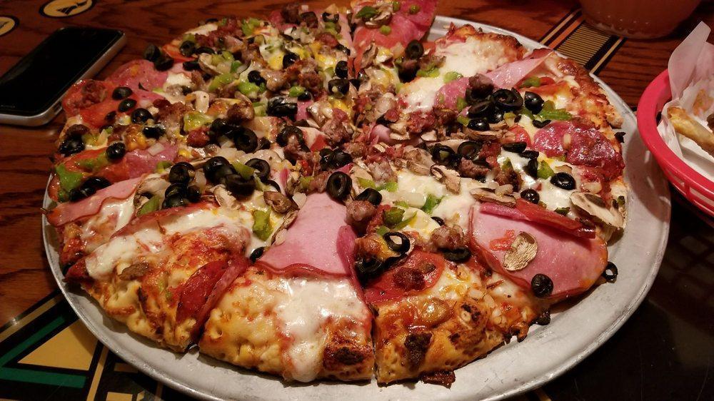 Combo Pizza · Canadian bacon, salami, pepperoni, mushroom, onion, green bell pepper, black olive, Italian sausage, linguica and beef on our classic red sauce.