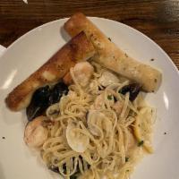 Seafood Linguini · Linguini pasta with shrimp, mussels, clams and scallops. Topped with parsley and Parmesan. S...
