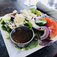 Greek Salad · Vegetarian. Spring mix and iceberg, tomatoes, English cucumbers, Kalamata olives, Bermuda on...
