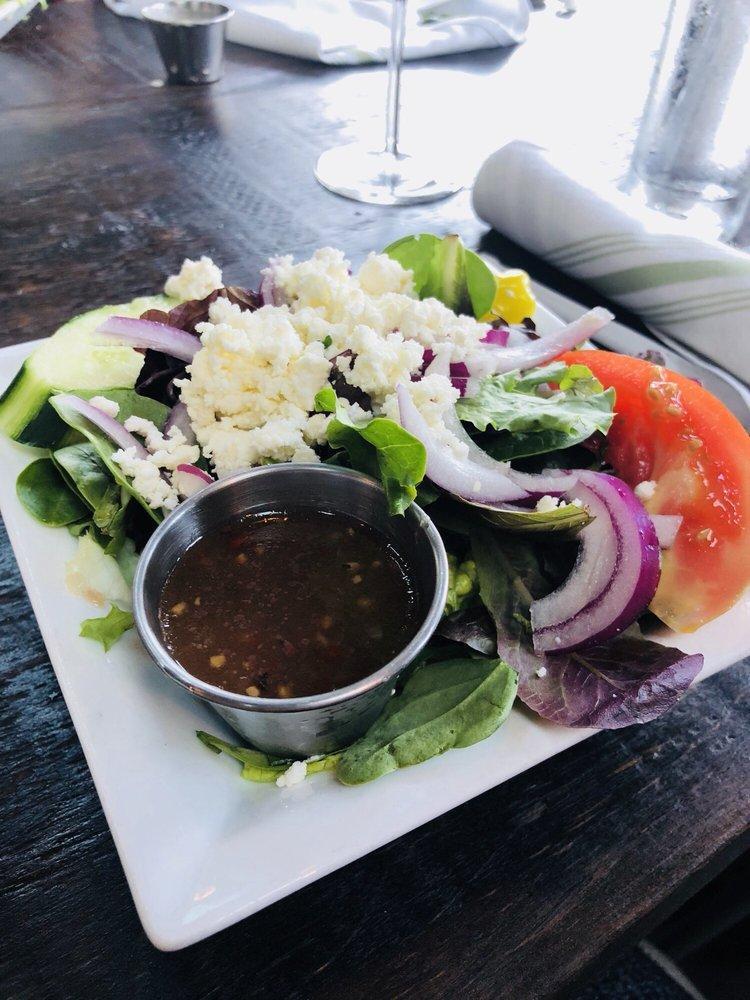 Greek Salad · Vegetarian. Spring mix and iceberg, tomatoes, English cucumbers, Kalamata olives, Bermuda onions, pepperoncini, feta cheese and roasted red pepper vinaigrette.
