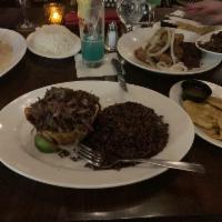 Vaca Frita · Famous crispy seared shredded flank steak, marinated with rumba’s mojo, cooked with red onio...