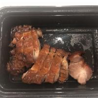 Barbecue Roast Pork · Sliced roasted pork served with a brown sweet sauce and garnished with scallions