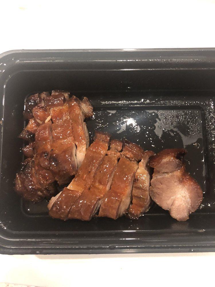 Barbecue Roast Pork · Sliced roasted pork served with a brown sweet sauce and garnished with scallions