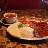 Carne Asada · Servido con arroz, frijoles y tajadas. Grilled steak: served with rice, beans, and sweet pla...
