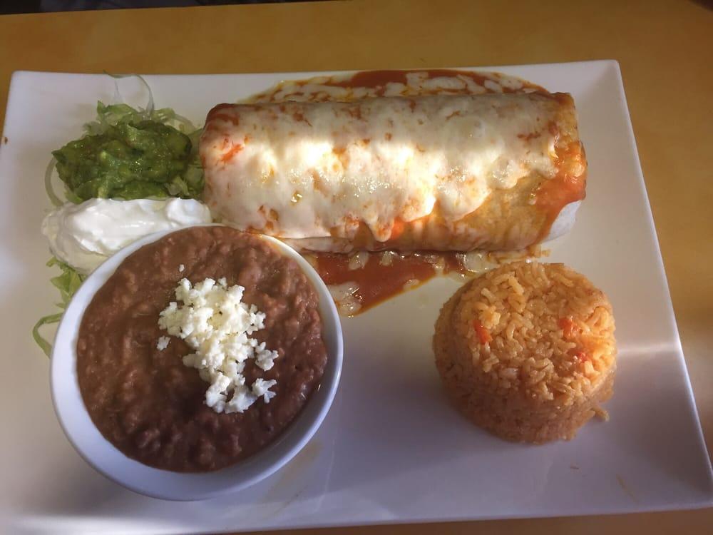 Wet Burrito · 1 flour tortilla filled with meat of your choice ground beef, barbacoa, chicken, pork, vegetable or carnitas. Rice, beans, lettuce, tomato and cheese. Topped with your choice of salsa verde, salsa roja, suiza sauce or mole and cheese. Add steak for an additional charge.