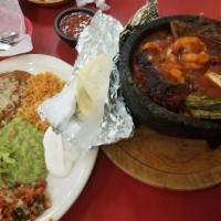 Molcajete · Steak, shrimp, chicken, rice, beans, mushrooms, nopales cactus and salsa.
