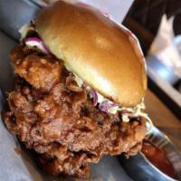 Crispy Chicken Sandwich · Pickle brined fried chicken breast, spicy honey mustard slaw, and dill pickle chips.