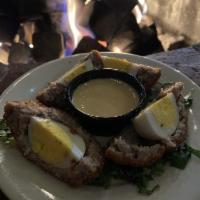 Scotch Egg · Hard Boiled Egg wrapped in Ground Sausage and Bread Crumbs, then deep fried. Served with a s...