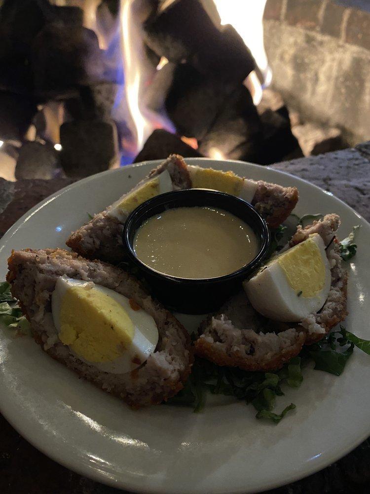 Scotch Egg · Hard Boiled Egg wrapped in Ground Sausage and Bread Crumbs, then deep fried. Served with a side of Spicy Mustard. You