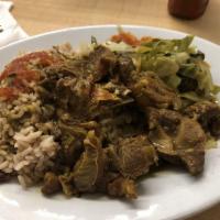 Curry Goat Dinner · Served with your choice of rice with peas, cabbage or salad.
