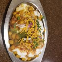 Papdi Chaat · Indian style nachos topped with spices, yogurt, potatoes, chickpeas, onions and a blend of s...