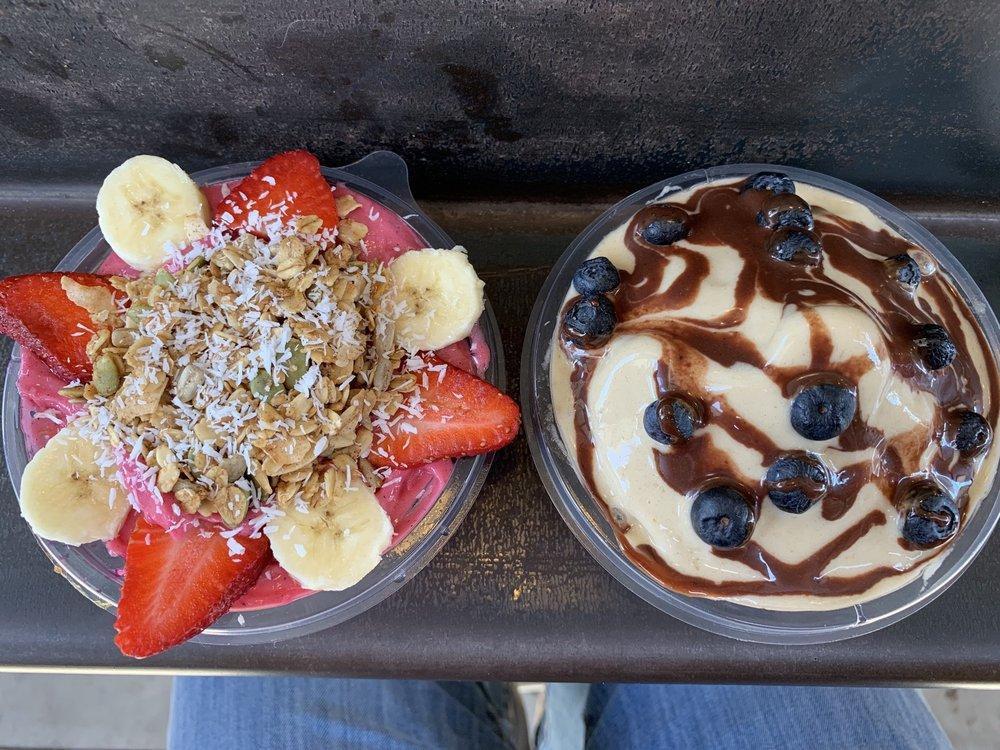 Mango Berry Bowl · Pitaya, bananas, mango, strawberries, local date puree and coconut milk. Topped with our house-made gluten-free granola, bananas and coconut flakes.