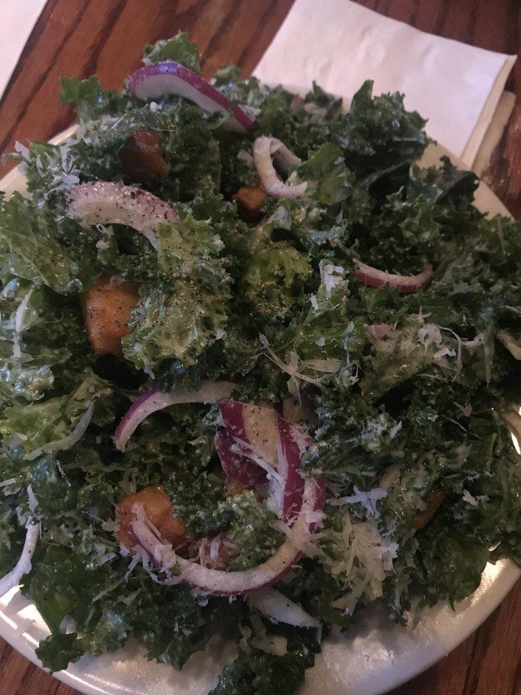 Kale Caesar Salad · Dressed kale greens with red onion and house croutons.