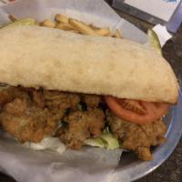 Fried Oyster Po' Boy Sandwich · Golden Fried oysters served with lettuce, tomato, and remoulade on a toasted ciabatta bread. 